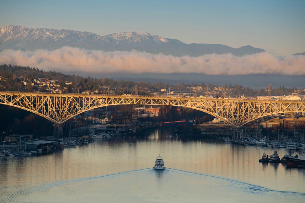 A breathtaking view of Seattle's Aurora Bridge at sunset with a serene river scene.