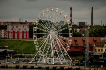 Explore the Klaipėda cityscape with a prominent Ferris wheel on the waterfront, Lithuania.
