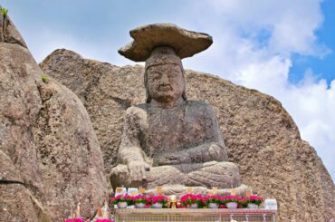 Ancient stone Buddha statue at Palgongsan, showcasing cultural heritage in Daegu, South Korea.