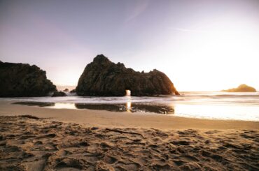 Breathtaking sunset at Pfeiffer Beach highlighting unique rock formations and serene ocean views.