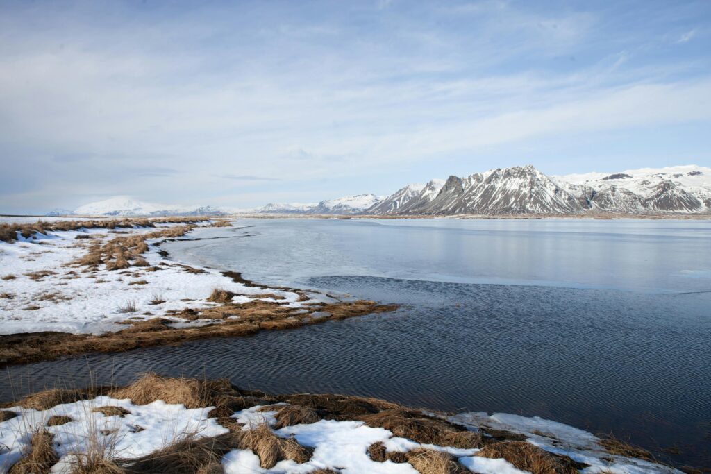Scenic winter view of snow-covered Borgarnes and mountains in Iceland.