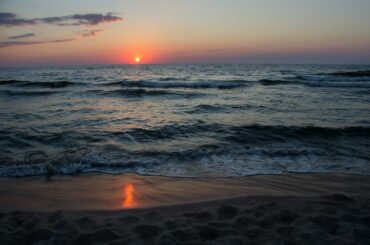 Stunning sunset view over the Baltic Sea at Palanga beach, Lithuania, capturing the tranquility of the waves.
