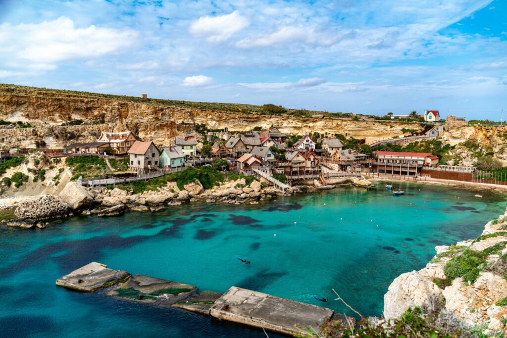 Picturesque view of Popeye Village with azure waters and coastal cliffs in Malta. Perfect travel destination.