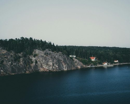 Picturesque aerial view of the coastal landscape in Stockholms län, featuring cliffs and serene waters.