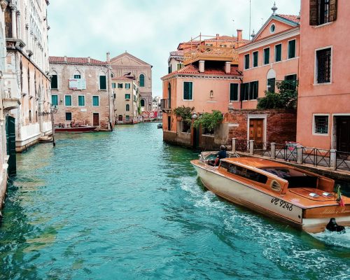 Picturesque view of Venice's canals with charming architecture and traditional boat.
