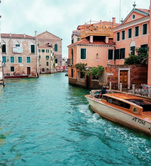 Picturesque view of Venice's canals with charming architecture and traditional boat.