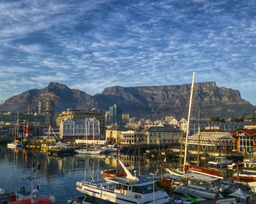 Stunning view of Cape Town harbor with boats and iconic Table Mountain backdrop.