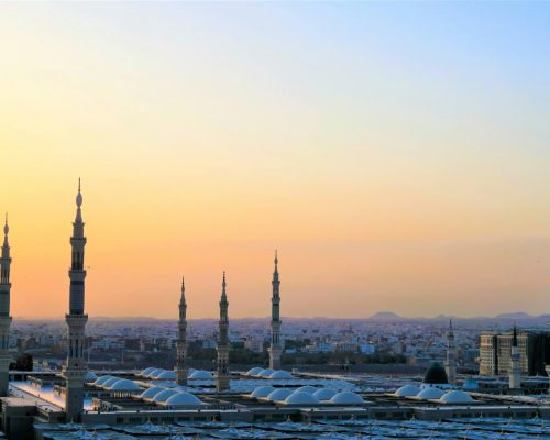 Stunning view of the Prophet's Mosque minarets at sunset in Medina, Saudi Arabia.