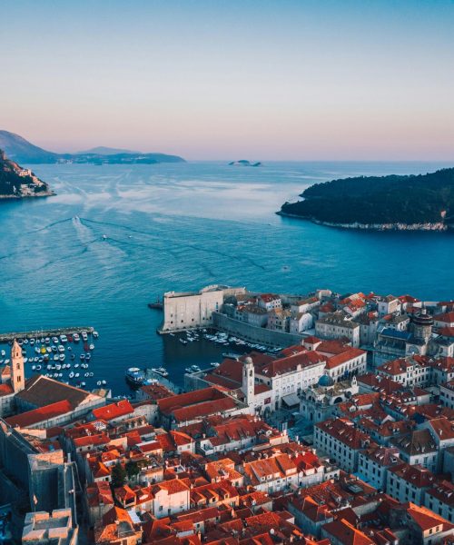 Breathtaking sunset over Dubrovnik's historic cityscape and Adriatic coast.