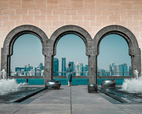 View of Doha skyline through Islamic arches at Museum of Islamic Art, Qatar.