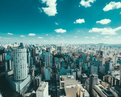Expansive aerial view of Sao Paulo showcasing skyscrapers and a vibrant urban skyline under a blue sky.